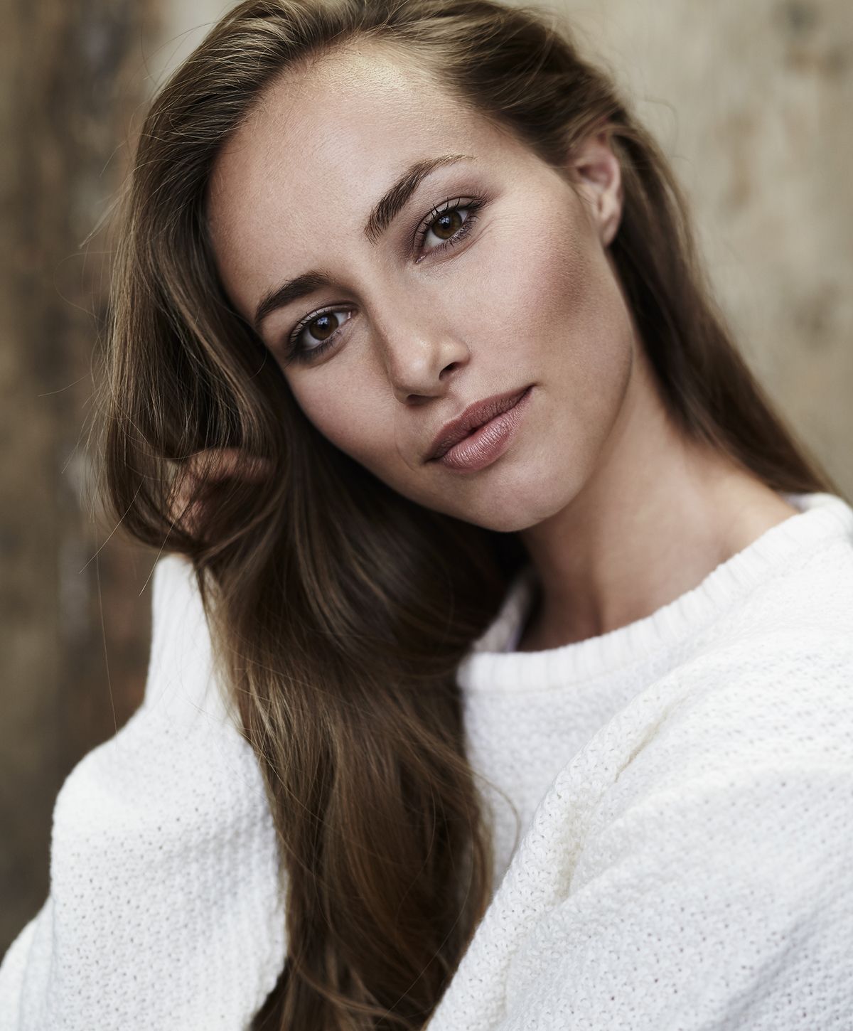 Portrait of a woman with long brown hair.