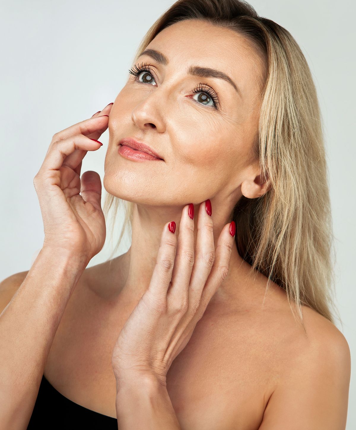 Woman touching her face, elegant beauty portrait.