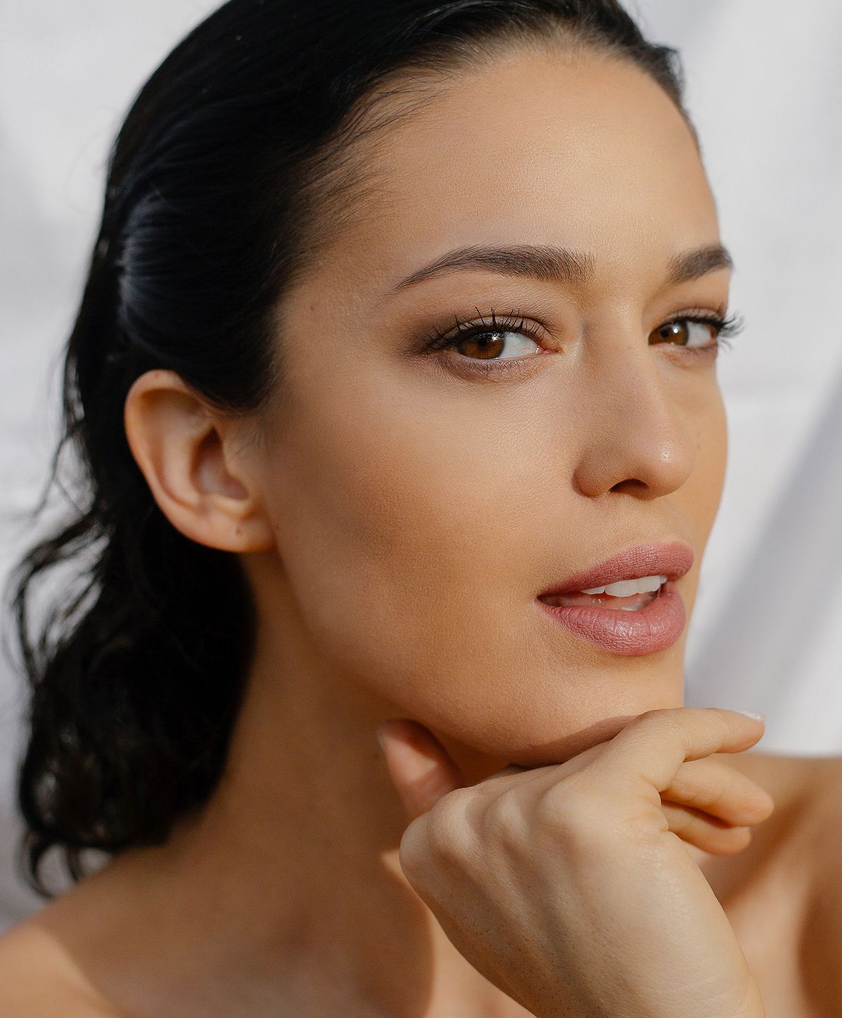 Close-up of a woman with thoughtful expression.