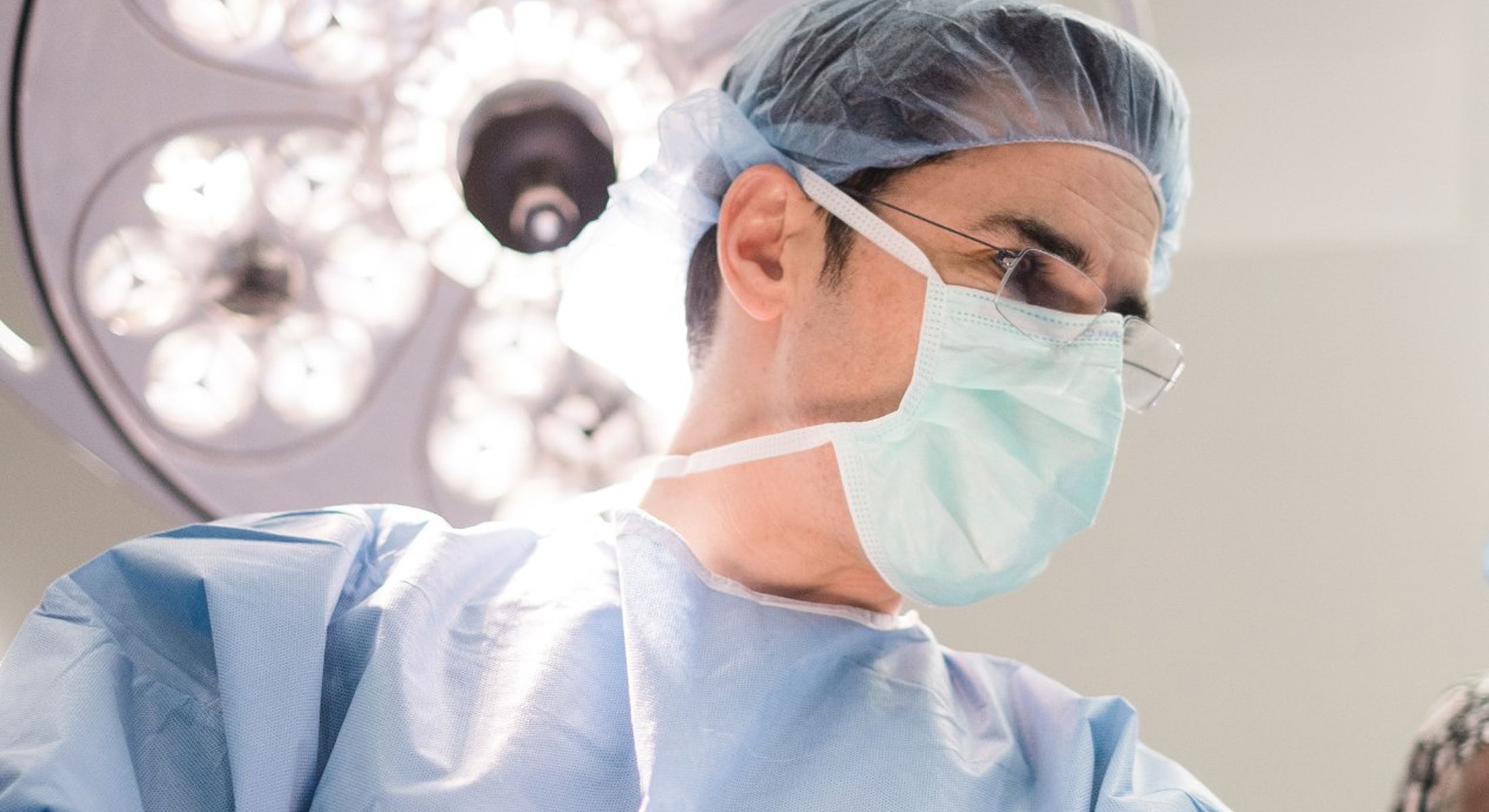 Surgeon preparing for a medical procedure in scrubs.