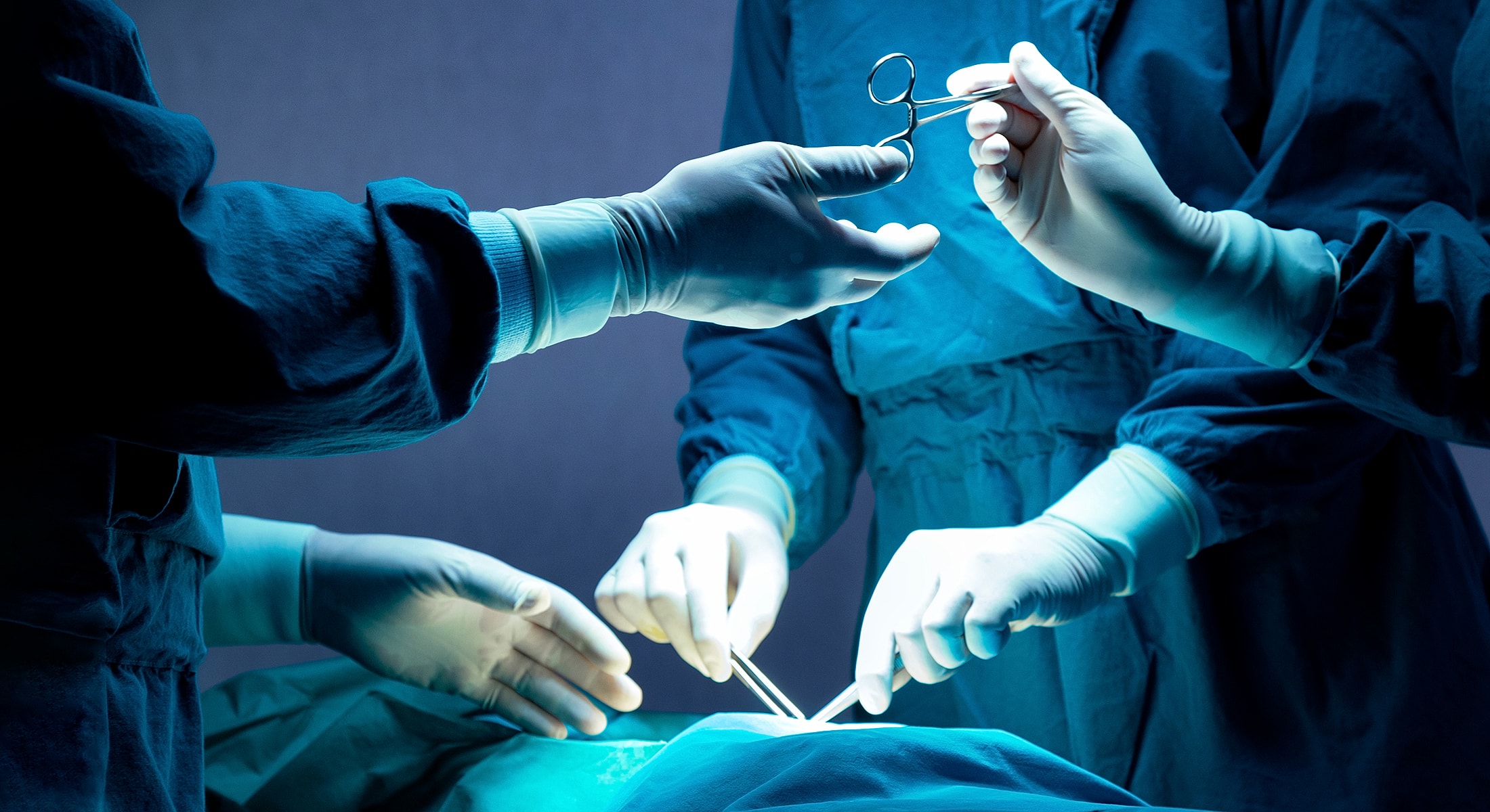 Surgeons performing a procedure in the operating room.