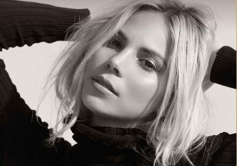 Black and white portrait of a woman with blonde hair.