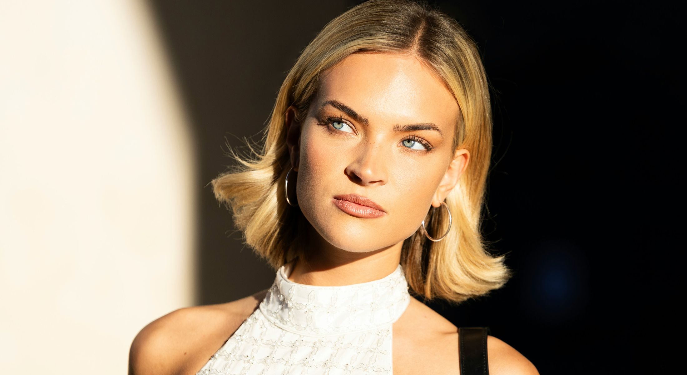 Woman with short hair and hoop earrings.